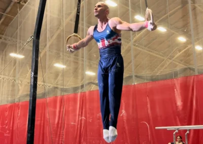 Coach Stefan Kolimechkov performing the Iron Cross on gymnastics rings, competing for the GB Master's Team in Boston USA