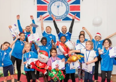 Children celebrating their gymnastics progress with Kensington & Chelsea Gymnastics Academy coaches at More House School in Knightsbridge SW1 London