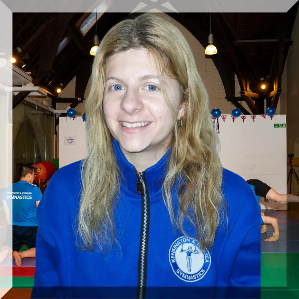 Gymnastics coach Venia from Kensington & Chelsea Gymnastics smiling in club uniform.