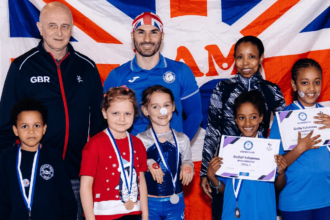 KCGA coaches and children at the Christmas Gymnastics Event 2022 awards ceremony in Kensington, London.
