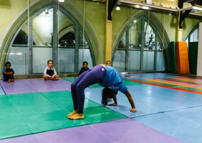 Child practising a backbend during the KCGA Christmas Gymnastics Event 2022 in Kensington, London W8.