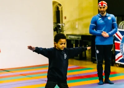 Child gymnast balancing a star shape at Chelsea Gymnastics Academy Christmas showcase.