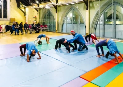 Children performing bridge positions during the KCGA Christmas Gymnastics Event 2022.