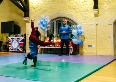 Child performing a handstand on gym mats during Chelsea Gymnastics Academy’s 2022 Christmas event in Kensington.