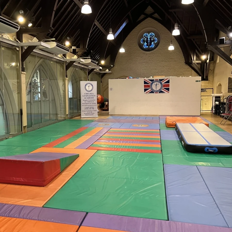 Children celebrating their gymnastics achievements at St Philip’s Church in Kensington W8 with Kensington & Chelsea Gymnastics Academy coaches