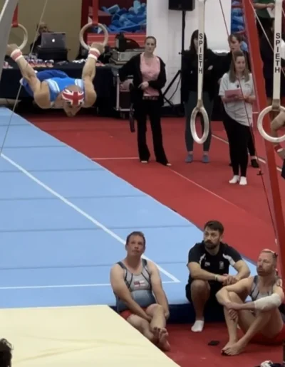 Coach Stefan performing a back lever on rings at the British Gymnastics Adult Championships 2023.