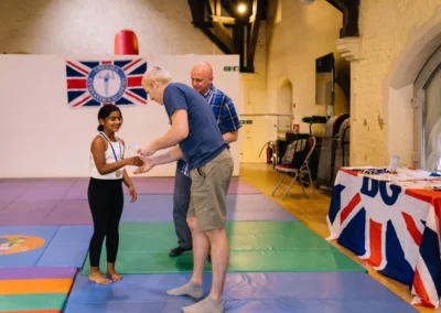 Welfare Officer and Head of the Kensington Studio awarding certificates and medals during KCGA Annual Performance 2023.