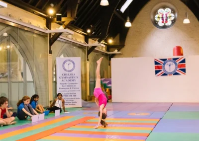 Young gymnast performing a cartwheel during the Annual Performance 2023 at KCGA in Kensington, London.