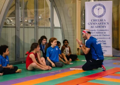 Coach Stefan explaining a gymnastics routine to his students during the Annual Performance 2023 at KCGA in Kensington.