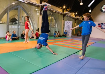 Coach Stefan and gymnast performing together during the Annual Performance 2023 at KCGA in Kensington, London.