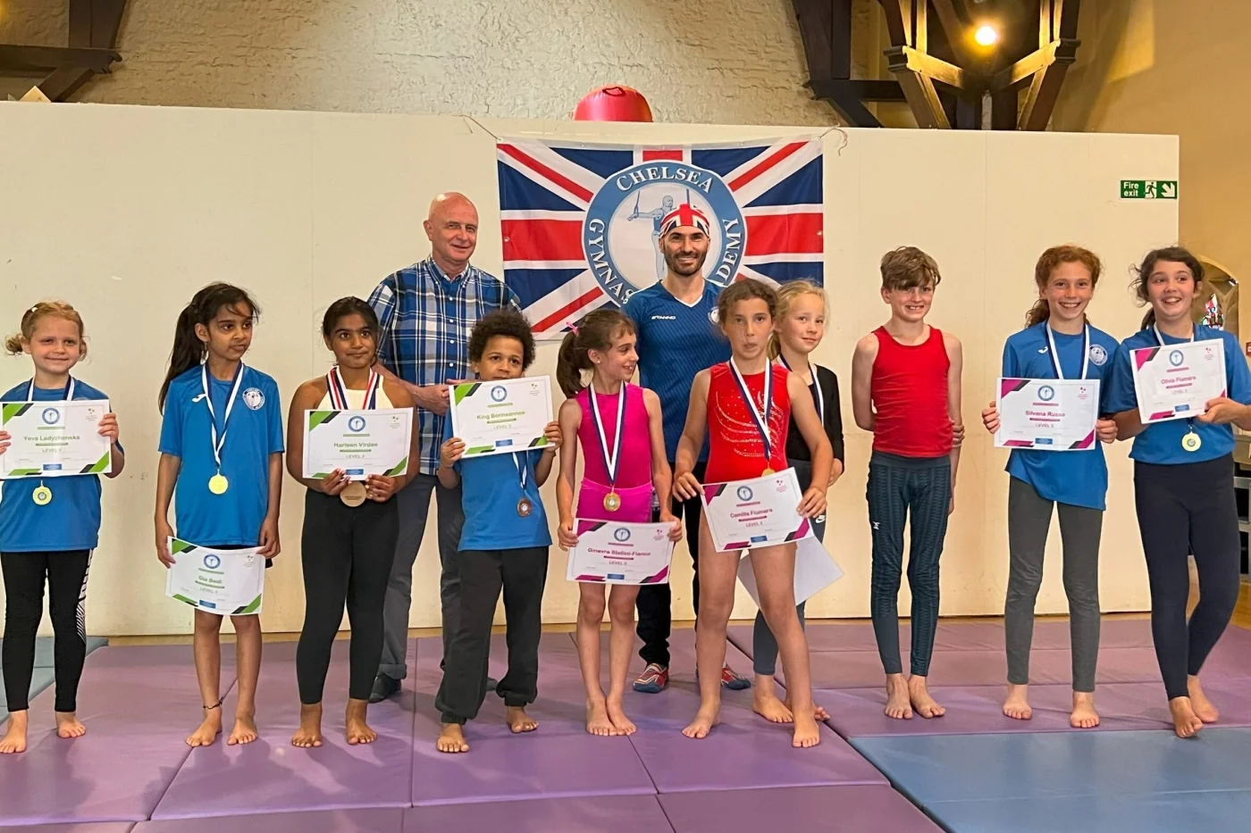 Group of gymnasts and coaches posing for a photo after the Annual Performance 2023 at Chelsea Gymnastics Academy in Kensington.