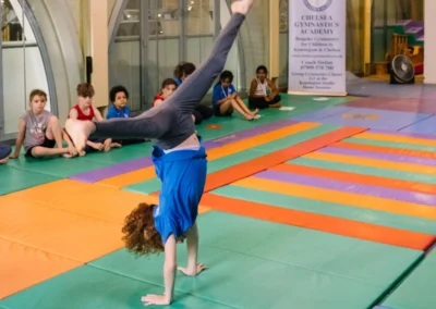 Gymnast performing a cartwheel during the Annual Performance 2023 at Kensington & Chelsea Gymnastics Academy.