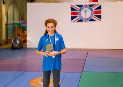 Gymnast Silvana holding her Gymnast of the Year 2023 award at Chelsea Gymnastics Academy in Kensington.