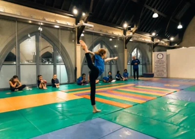Young gymnast performing a balance pose at KCGA Easter gymnastics event in Kensington London W8.