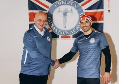 Two KCGA coaches standing together at Chelsea Gymnastics Academy Easter event Kensington London W8.