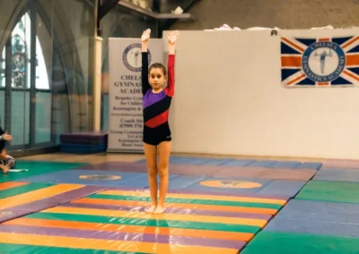 Young gymnast maintaining posture during KCGA Easter gymnastics event Kensington London W8.