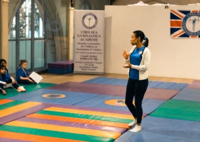 KCGA welfare officer speaking to children during Easter gymnastics event in Kensington London W8.