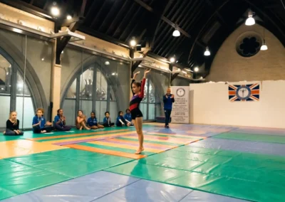 Young gymnast performing at Chelsea Gymnastics Academy Easter gymnastics event West London W8.