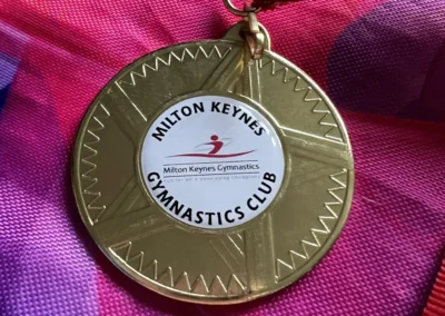 Gold medal from Milton Keynes Gymnastics Adult Competition 2023 on a ribbon.