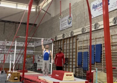 Gymnast Stefan Kolimechkov presents before his rings routine at the masters gymnastics competition in Milton Keynes in 2023