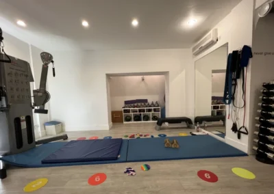 Gymnastics mats, wall mirrors, and conditioning equipment inside The Kensington Studio in Kensington London W8