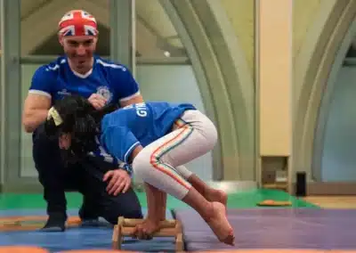 Child performing a frog balance exercise during a gymnastics class in Kensington London
