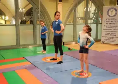 Children warming up before gymnastics activities at Kensington & Chelsea Gymnastics Academy