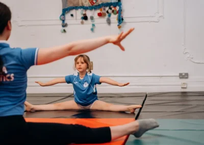 Child practising flexibility in a gymnastics class for children in Knightsbridge London SW1X