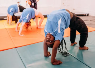 Children performing bridge positions during gymnastics classes for children in Knightsbridge SW1X