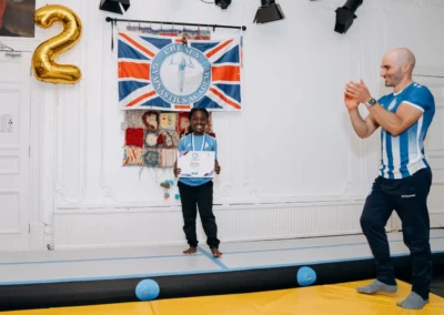 Child holding a certificate during gymnastics classes for children in Knightsbridge SW1X