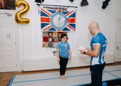 Child receiving recognition during gymnastics classes for children in Knightsbridge London