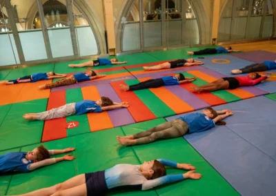 Children in floor formation during gymnastics performance in Kensington London