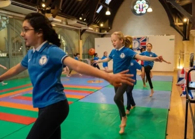 Children practising balance during gymnastics performance in Kensington London