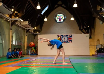 Child performing backbend during gymnastics performance in Kensington London