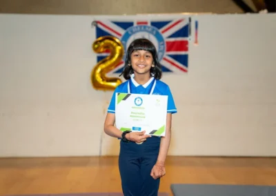 Child holding gymnastics certificate at KCGA Annual Performance 2024 in Kensington London