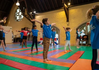 Children stretching and working on posture at gymnastics performance in Kensington