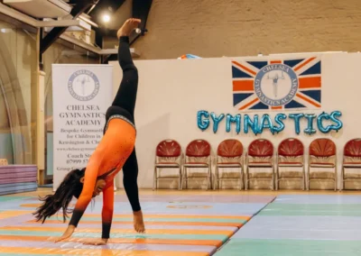 Gymnast performing a cartwheel at the 2023 Christmas performance with Kensington & Chelsea Gymnastics Academy.