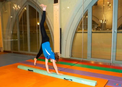 Child balancing on beam during Easter 2025 gymnastics class at Kensington & Chelsea Gymnastics Academy