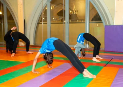 Child performing a bridge exercise during Easter 2025 gymnastics session at Kensington & Chelsea Gymnastics Academy