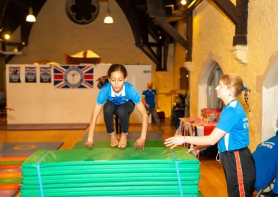Children learning vault gymnastics techniques during Easter 2025 sessions at a London gymnastics club.