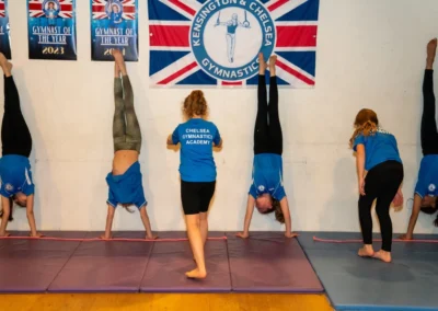 Child gymnast performing a controlled handstand during Easter 2025 training at KCGA