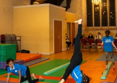 Child practising gymnastics balance and cartwheel drills during Easter 2025 group class coaching in London
