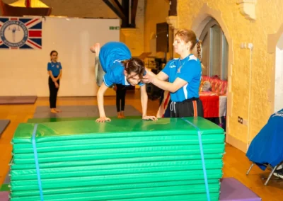 Child learning a squat through gymnastics movement during an Easter 2025 private coaching session at KCGA in Kensington, London.