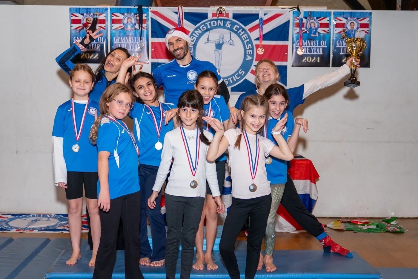 KCGA gymnasts and coaches celebrating together at a community gymnastics event in London, December 2025.