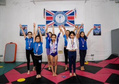 KCGA gymnasts celebrating achievement during a student spotlight session at the Knightsbridge gymnastics location in London SW1X, December 2025.