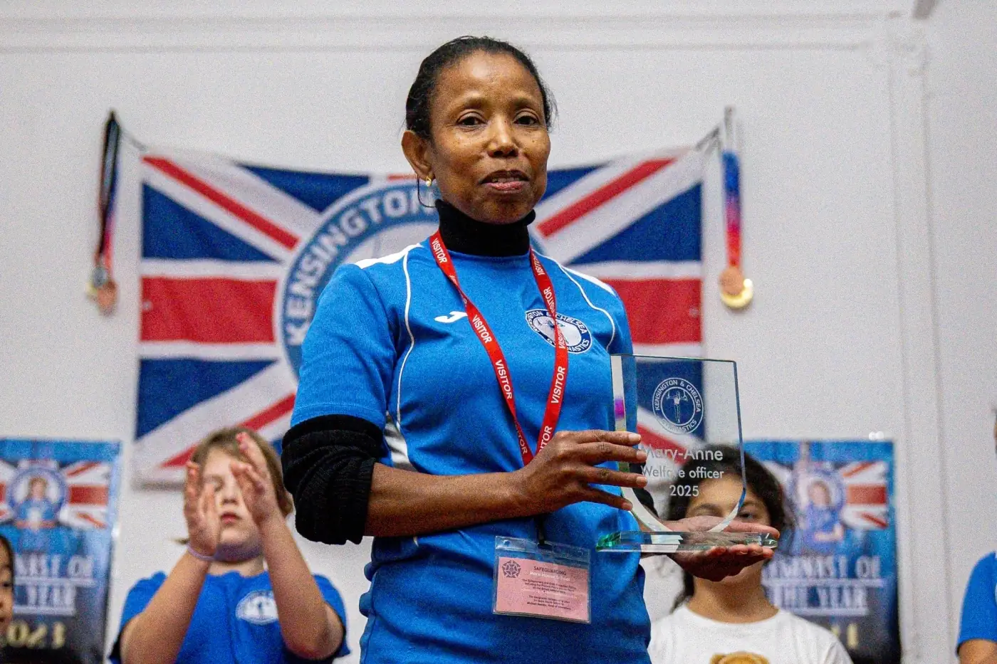 KCGA Welfare Officer receiving recognition for safeguarding and community support at Kensington & Chelsea Gymnastics Academy, December 2025.