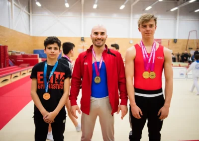 Stefan Kolimechkov with his gymnasts Matthew (left) and Fergus (right) winning medals for the Elite Gymnastics Academy at the 2017 London Championships