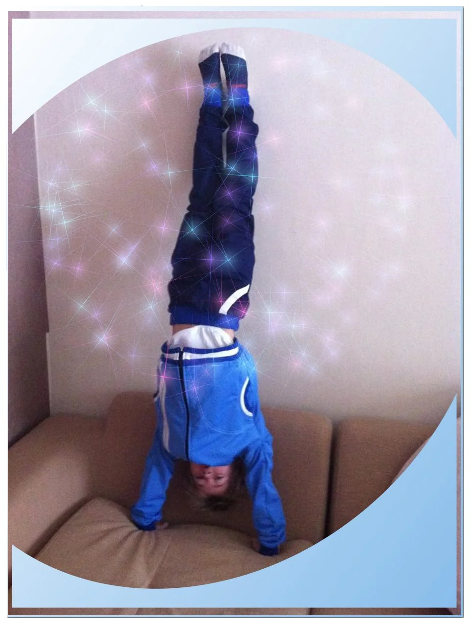 Child practising a supported handstand during a home gymnastics lesson in Kensington and Chelsea, London