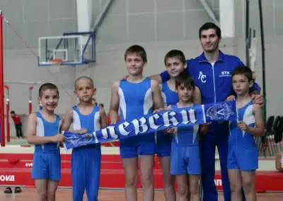 Coach Stefan Kolimechkov with boys’ artistic gymnasts at the Bulgarian National Championships, 2011