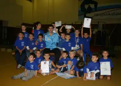 Coach Stefan Kolimechkov with young gymnasts during a gymnastics show event in Bulgaria, 2011